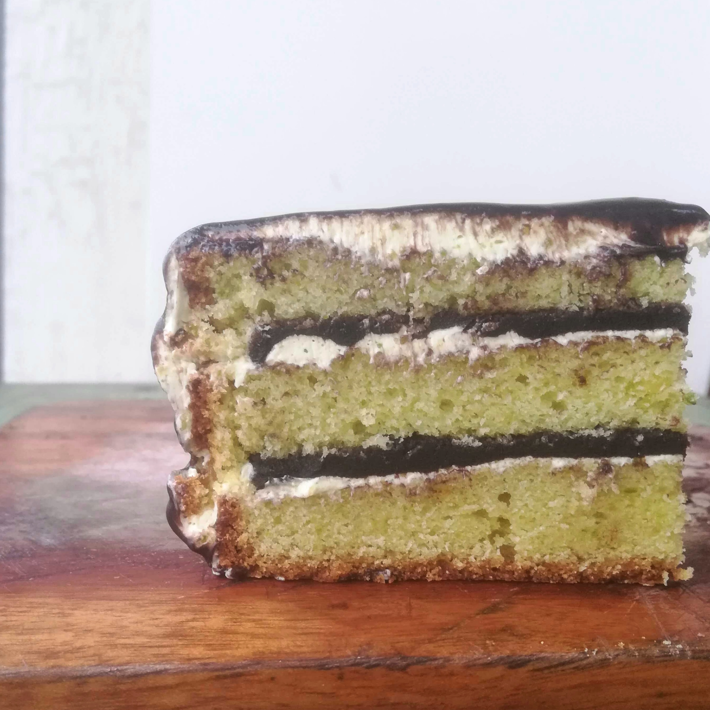 Dark chocolate pistachio layer cake with buttercream frosting.